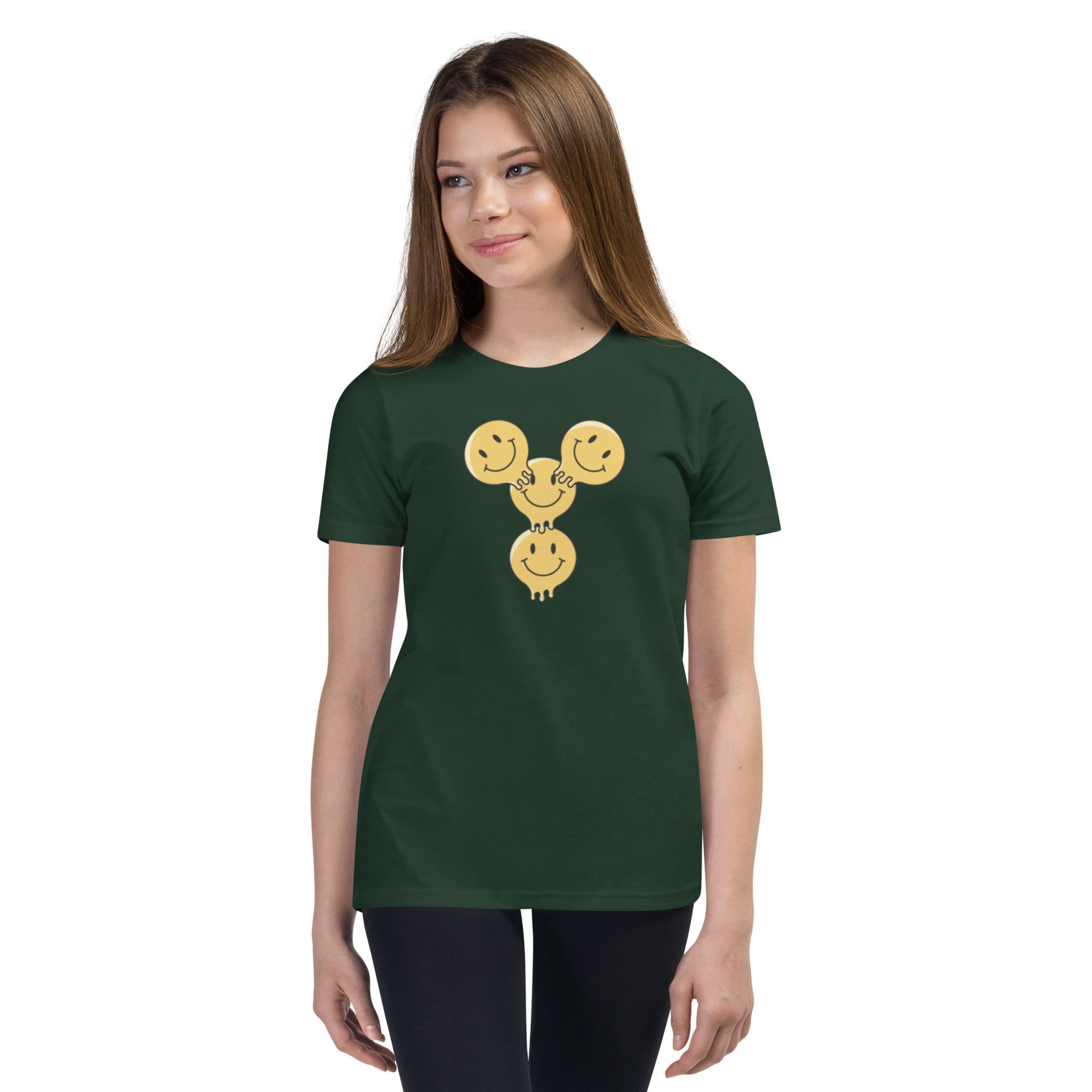 Girl wearing green shirt with smiley design.