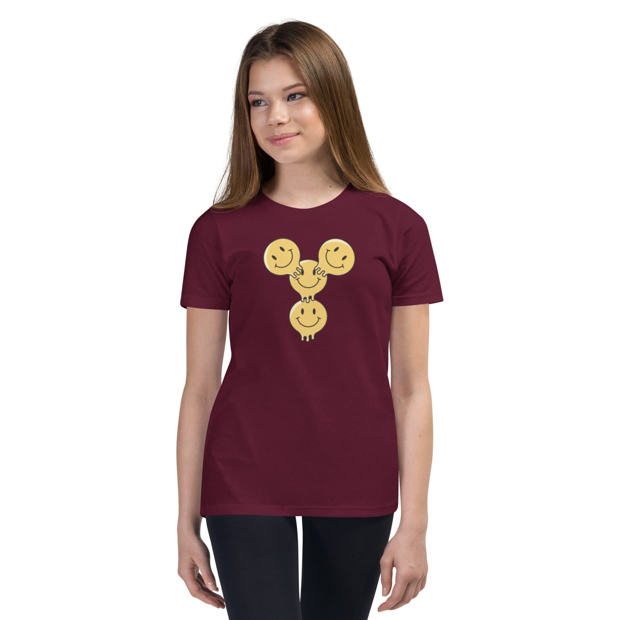 Girl wearing maroon shirt with smiley design.