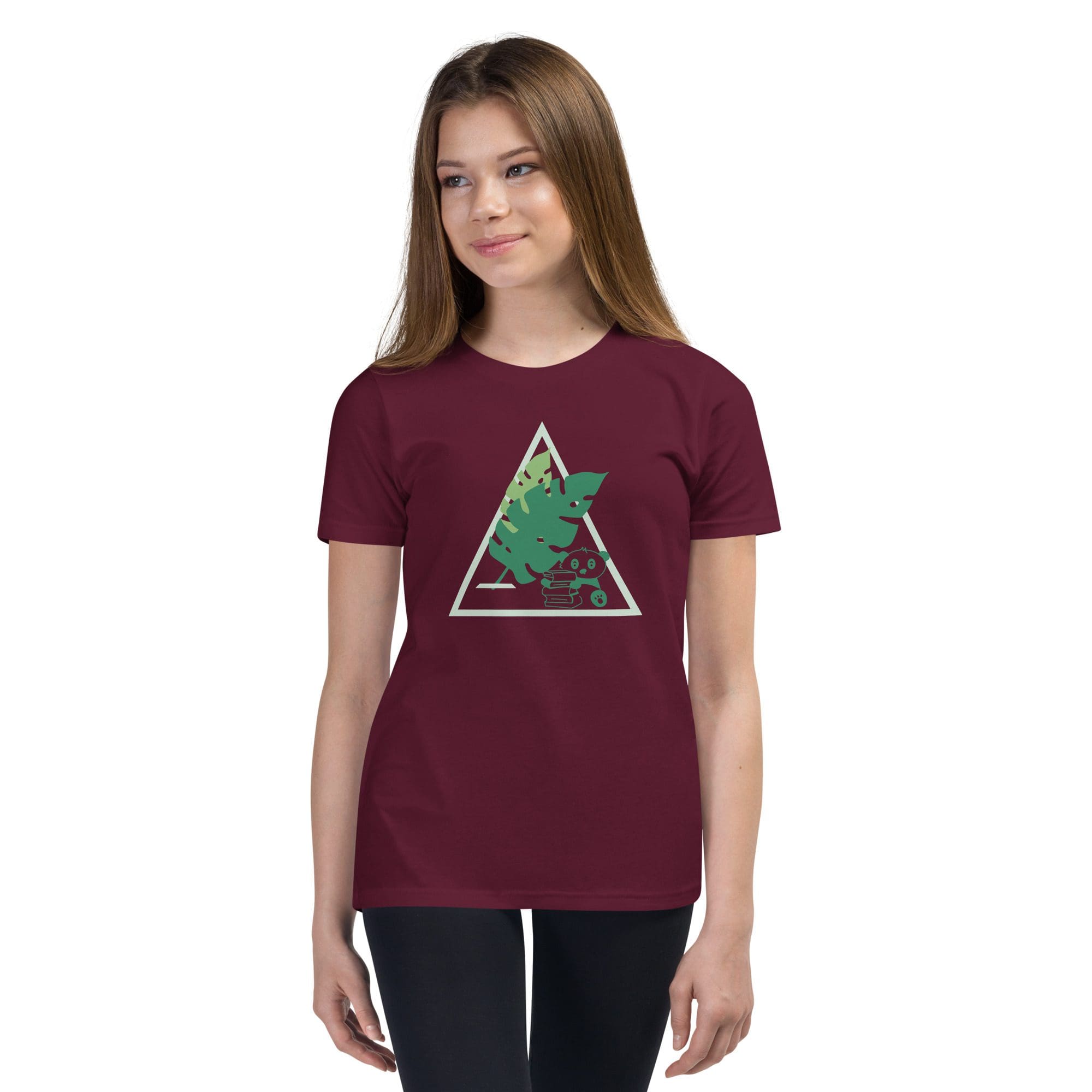 Girl wearing maroon shirt with tree design.