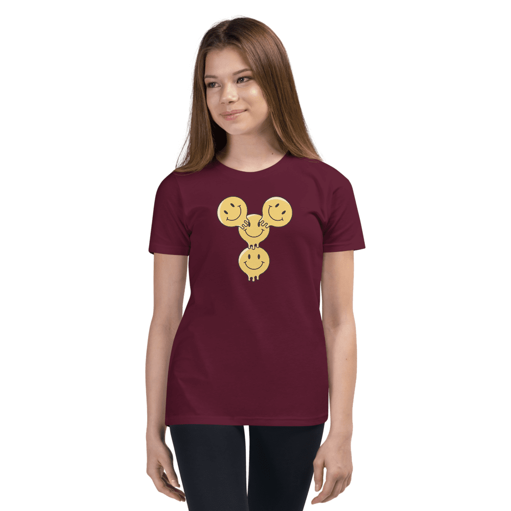 Woman wearing maroon shirt with smiley faces.