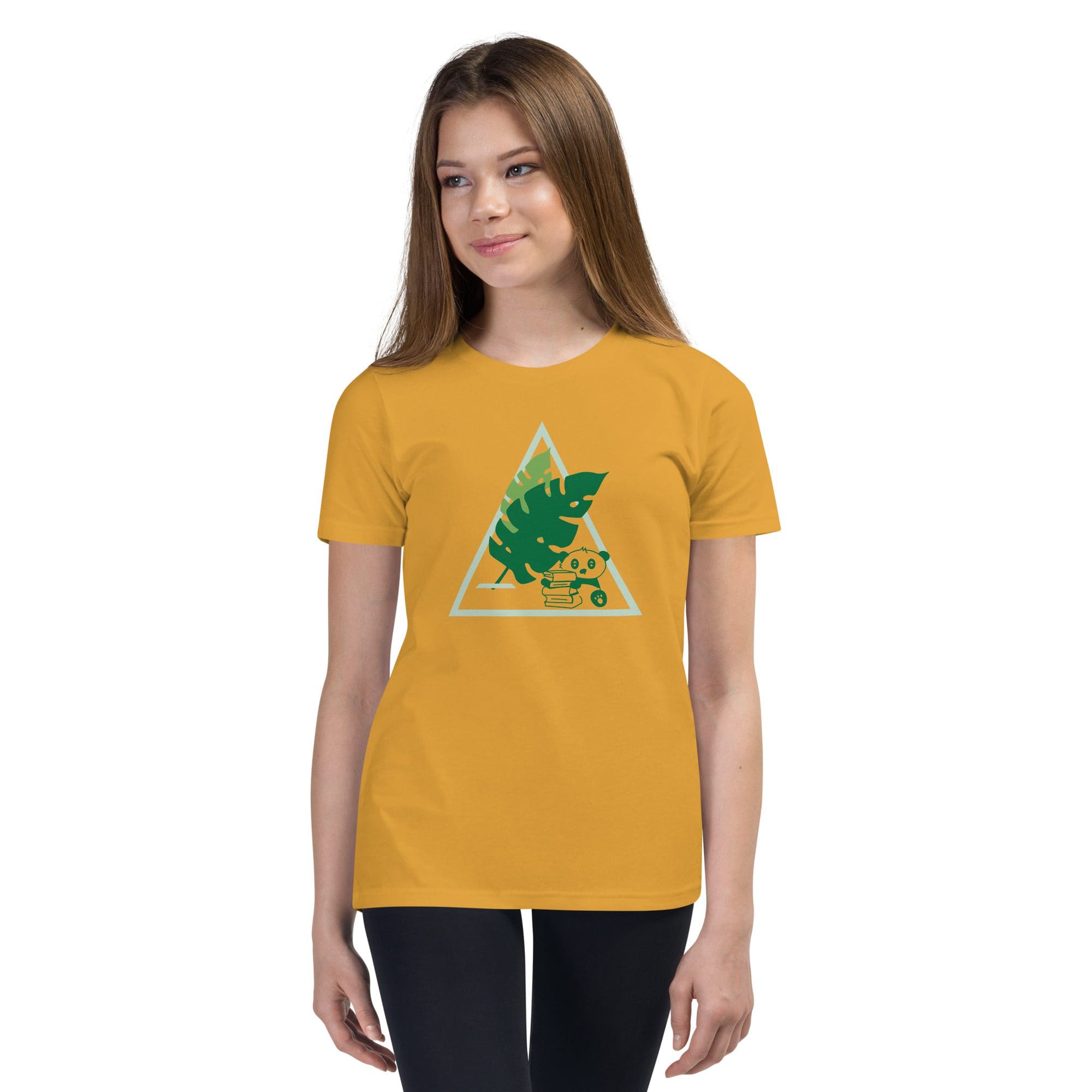 Young girl wearing yellow geometric patterned shirt.