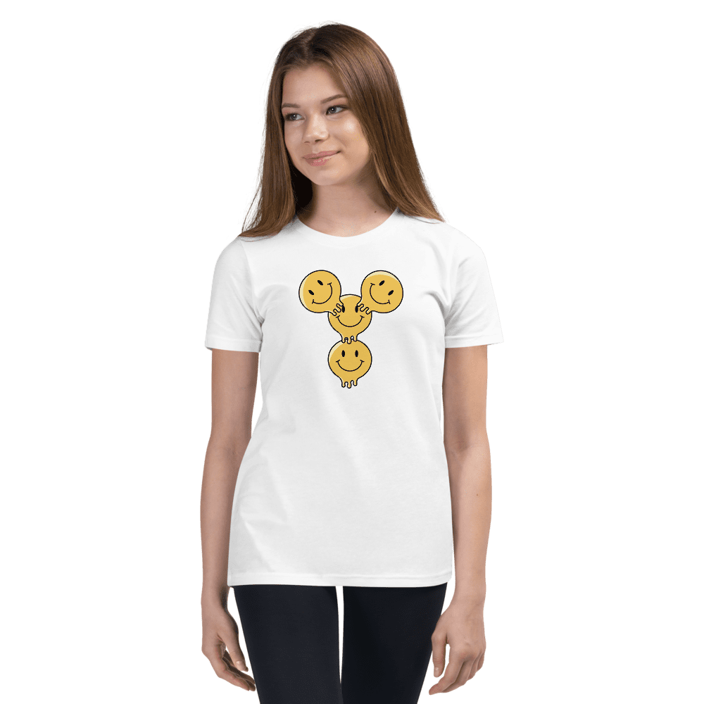 Woman wearing smiley face t-shirt, black background.