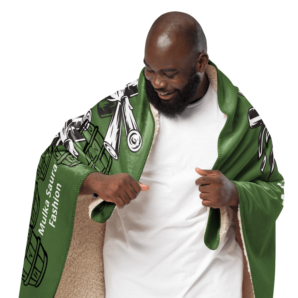 Smiling man wrapped in green patterned blanket