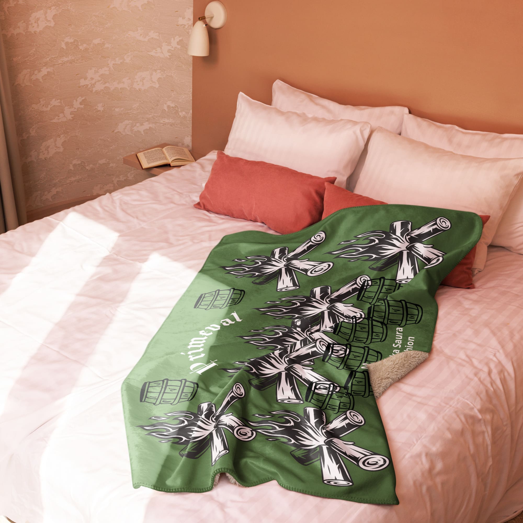 Green blanket with campfire design on bed.