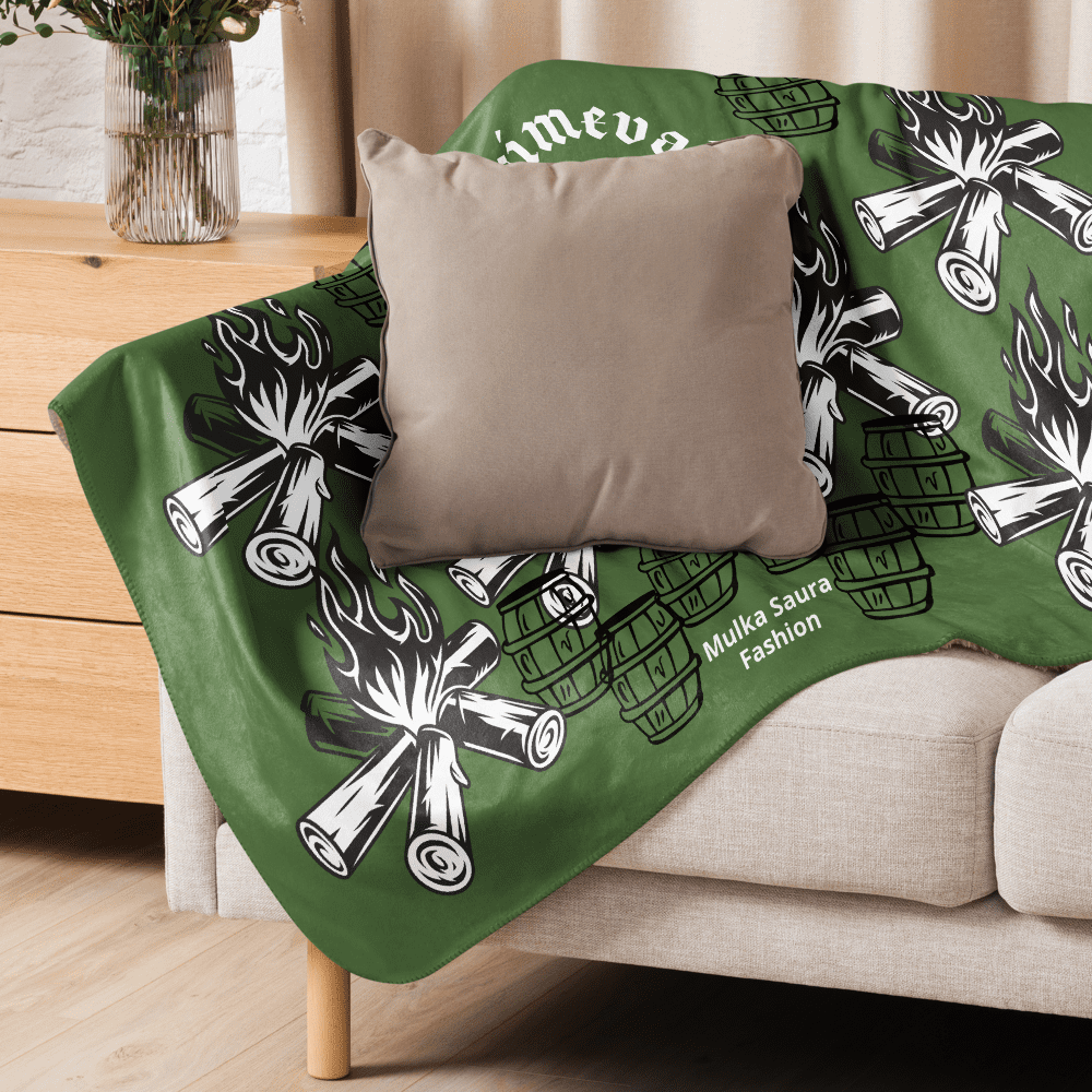 Green campfire-patterned throw on beige sofa