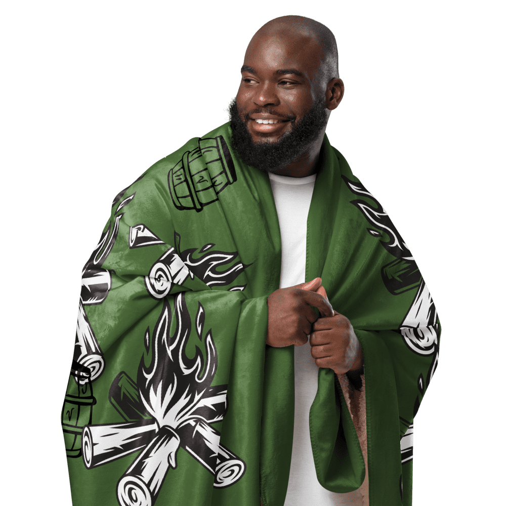 Smiling bearded man in green campfire blanket