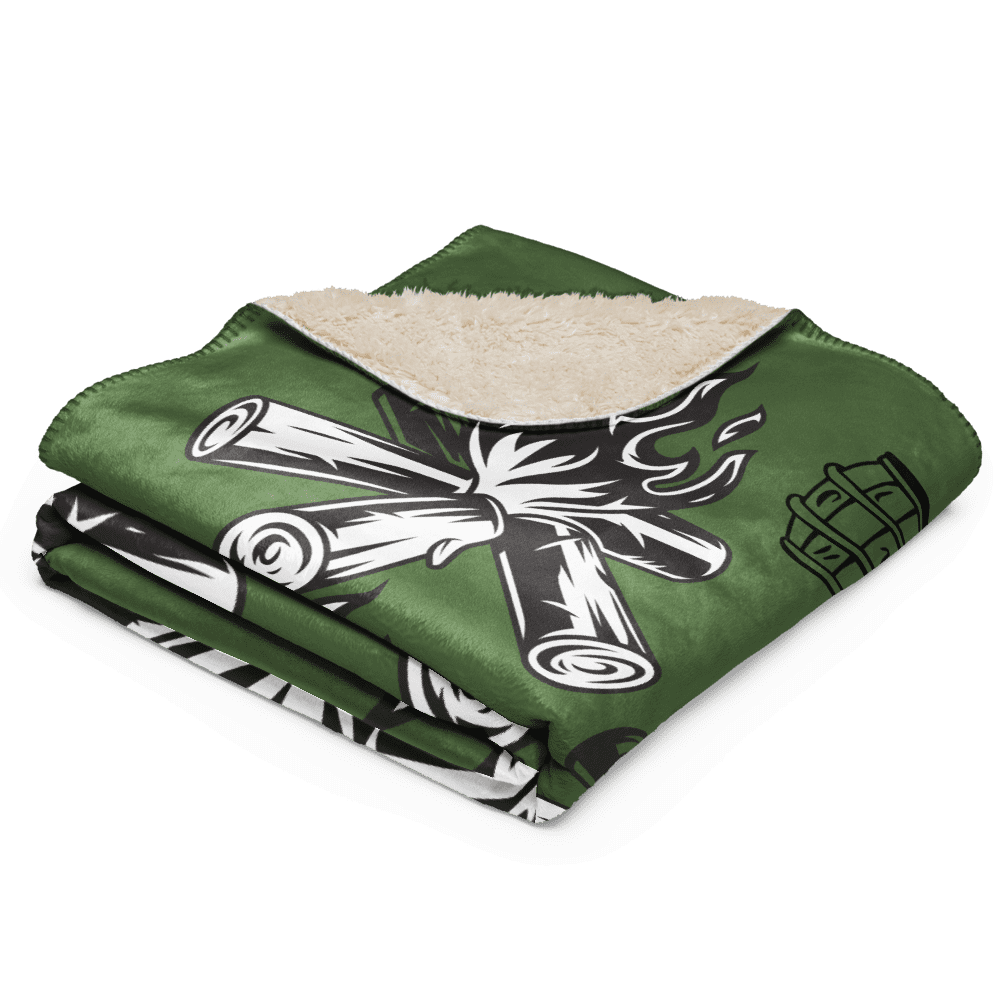 Folded green sherpa blanket with campfire design