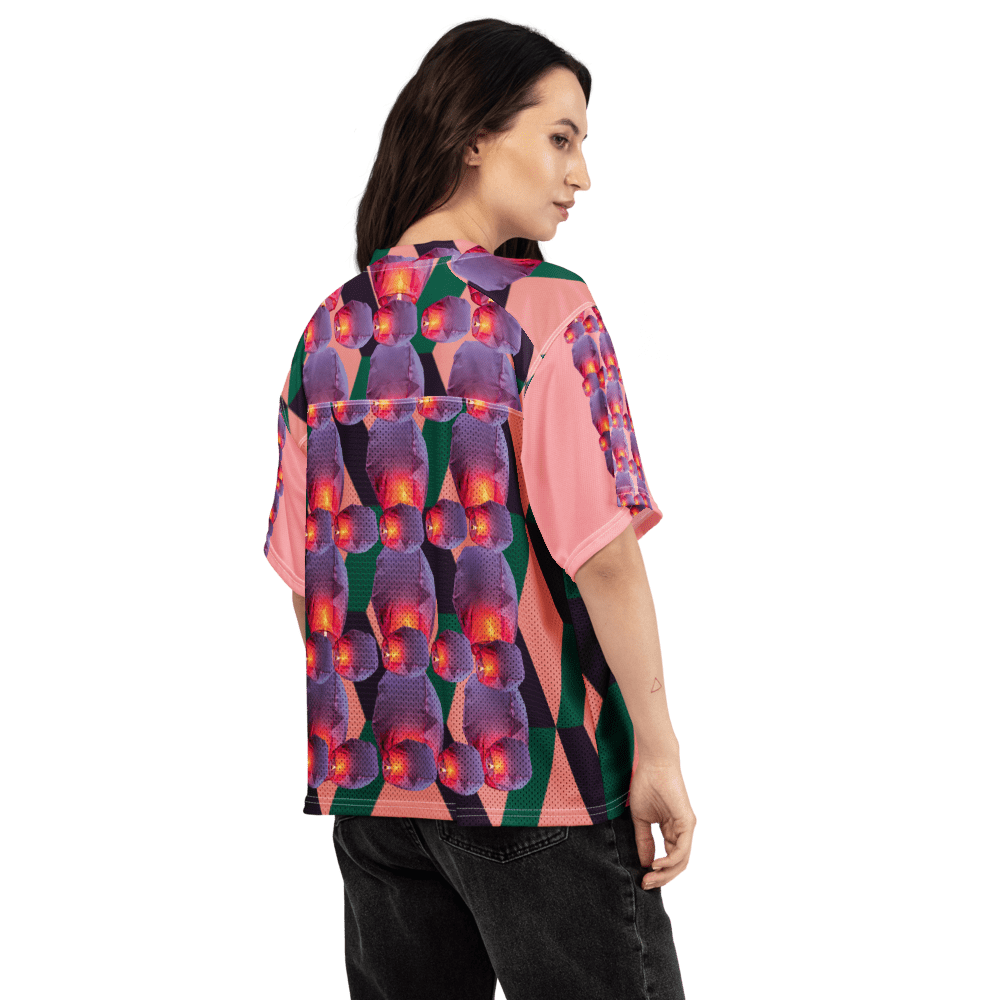 Woman wearing vibrant geometric floral print shirt
