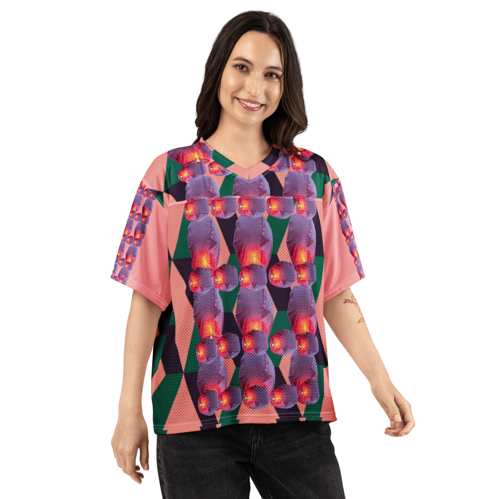 Smiling person wearing colorful geometric patterned shirt