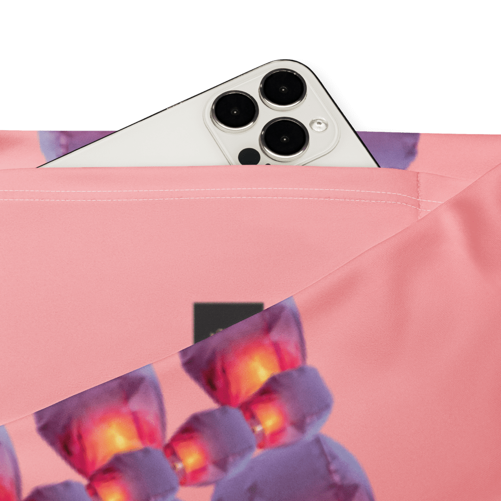 White smartphone camera peeking from pink fabric