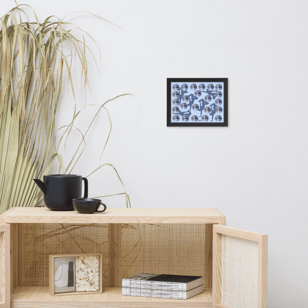Light wood cabinet with black teapot and framed art