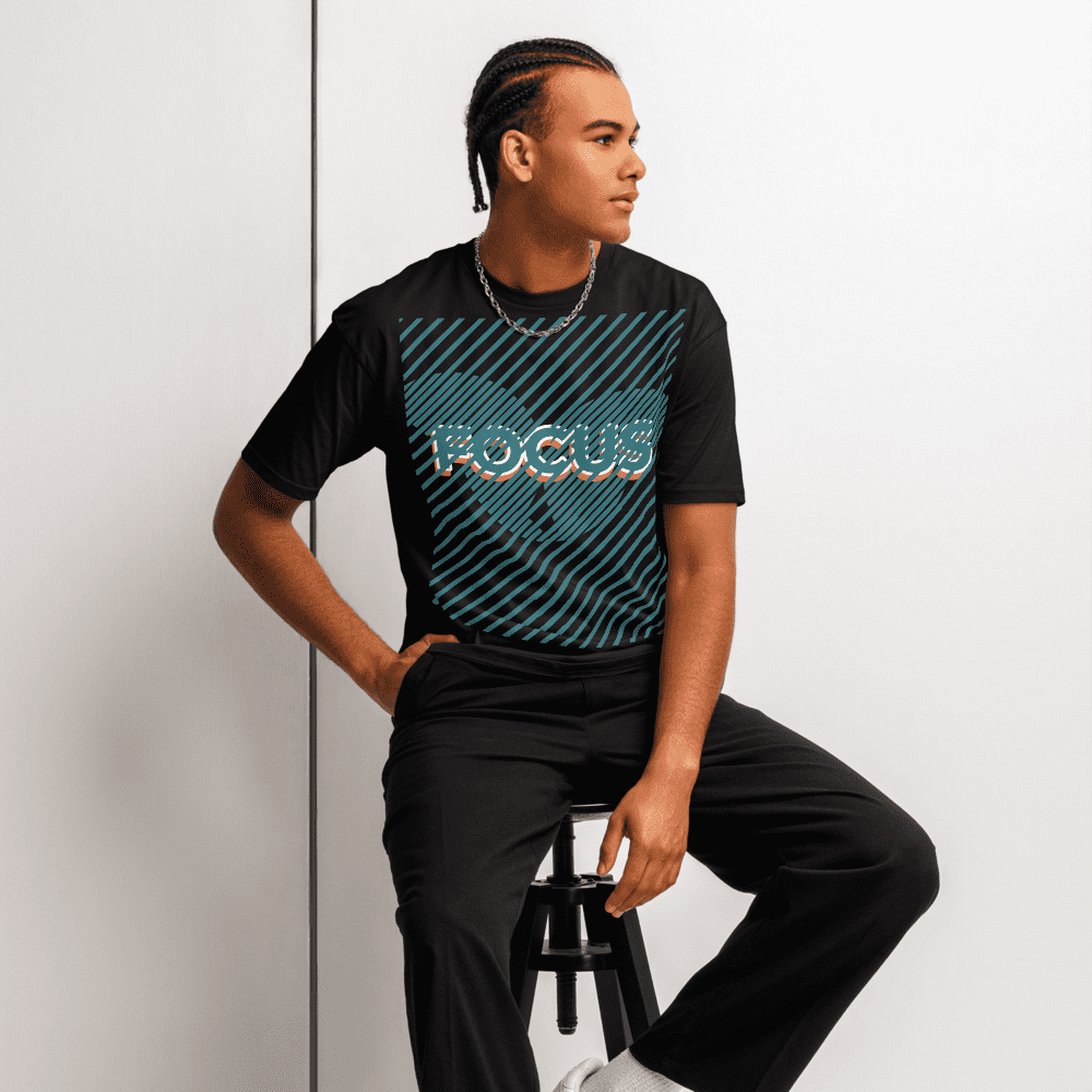 Man seated on stool wearing FOCUS t-shirt