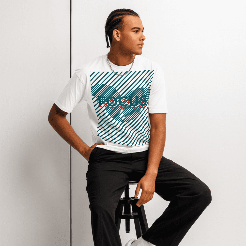 Man sitting on stool wearing "FOCUS" T-shirt